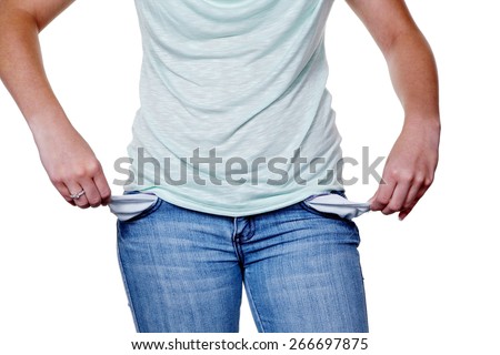 a young woman showing empty pockets of their jeans. symbolic photo for debt.