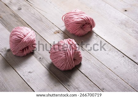 pink balls of wool on old wooden