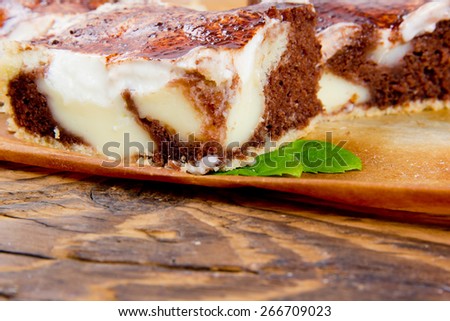 Photo of sliced cream cake on wooden board