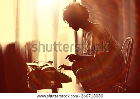 girl typing on a typewriter Royalty-Free Stock Photo #266718080