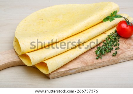 Tortilla stack with herbs on the wood background
