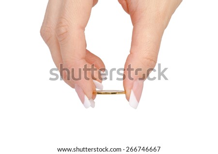 Female hand holding a coin  on a white background.