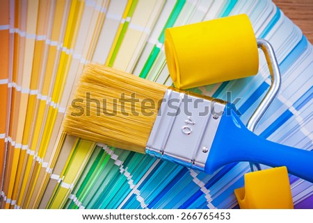 paintbrush and paint roller on color palette 