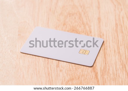 White blank credit card on wood board.