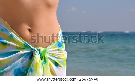 Woman belly and ocean