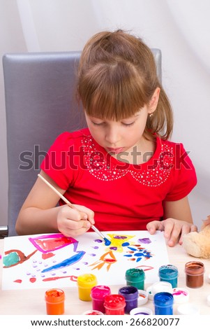 Beautiful girl paints a picture of colored inks