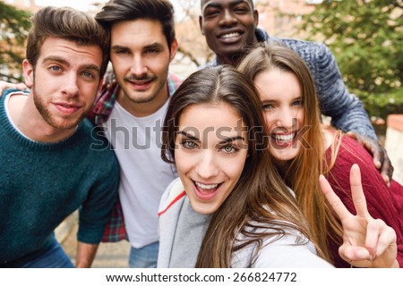 Group of multi-ethnic young people having fun together outdoors Royalty-Free Stock Photo #266824772
