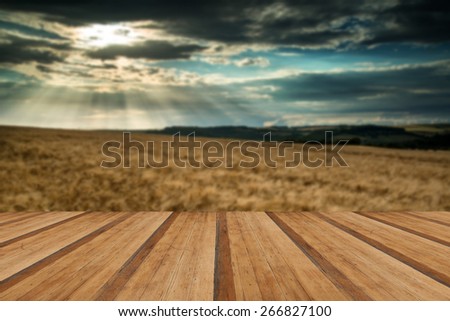 Stunning countryside landscape wheat field in Summer sunset with wooden planks floor