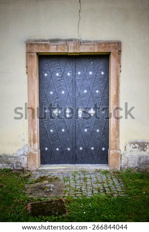 Metal massive door in an ancient fortress Europe.