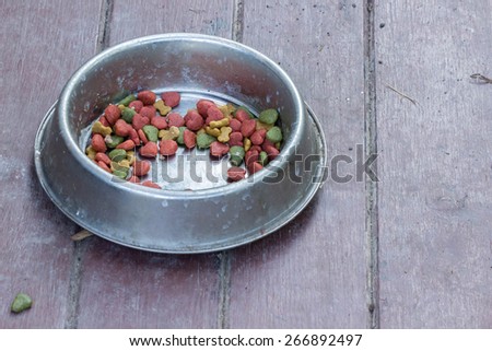 Silver dog dish or feeding bowl on wooden floor