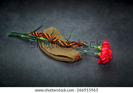 Carnation flowers, George Ribbon and military garrison cap with a red star. 70 Years of Victory in the Great Patriotic War