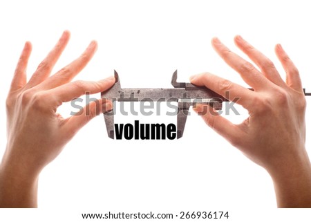 Color horizontal shot of two hands holding a caliper and measuring the word "volume".
