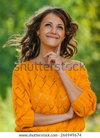 portrait young charming woman long-haired curly smiles background summer green forest