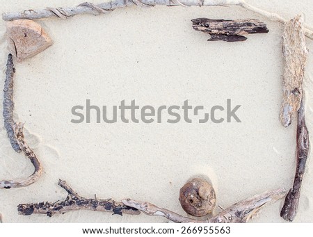Arranged in a wooden frame on the beach.