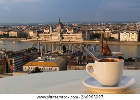 Cup of coffee with a view of the parliament building in Budapest (horizontal picture, the building in focus)
