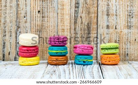 Colorful macarons on vintage pastel background. Macaron or Macaroon is sweet meringue-based confection.