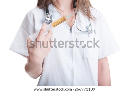 Young, beautiful and confident female doctor holding a syringe and smiling on white background