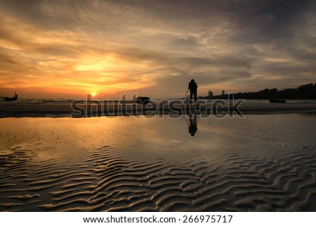 photographer  taking a Landscape photo sunset at seaside.