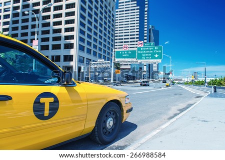 Taxi parked in Downtown Manhattan on a sunny day.