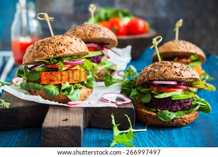 Veggie beet and carrot burgers with avocado Royalty-Free Stock Photo #266997497