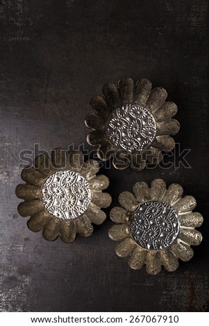 abstract picture with Vintage Baking Tins or molds on dark metal background