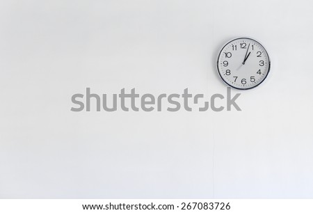 Round metal clock on white wall