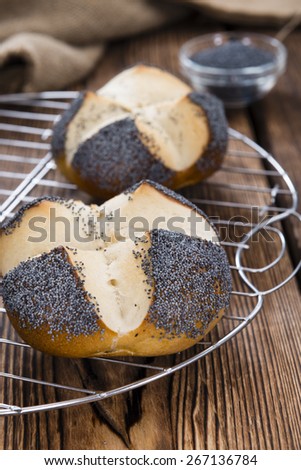 Homemade Pretzel Roll (with Poppyseed) on rustic wooden background