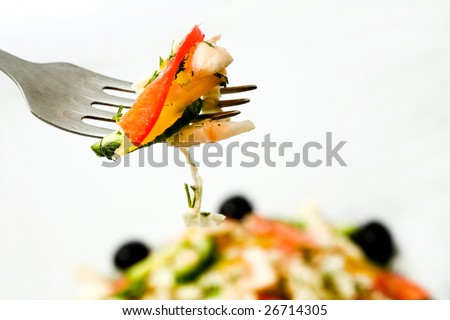 Stock photo: an image of a fork with some salad on it
