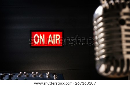 lighting of on air signboard in sound studio and retro  microphone is foreground Royalty-Free Stock Photo #267163109