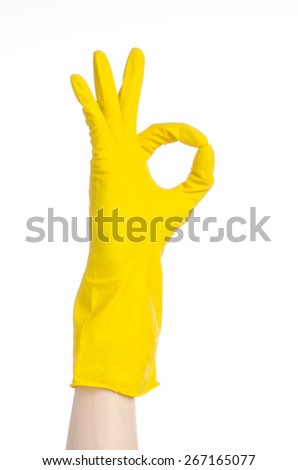 Homework, washing and cleaning of the theme: man's hand holding a yellow and wears rubber gloves for cleaning isolated on white background in studio