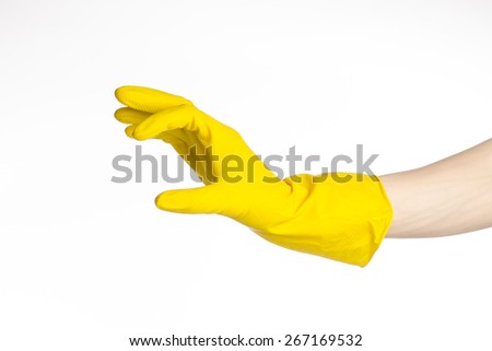 Homework, washing and cleaning of the theme: man's hand holding a yellow and wears rubber gloves for cleaning isolated on white background in studio