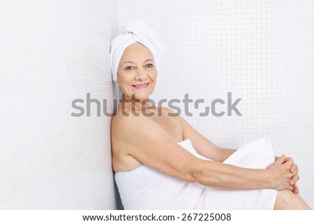 Elderly woman sitting releaxed in a relaxation room in spa Royalty-Free Stock Photo #267225008
