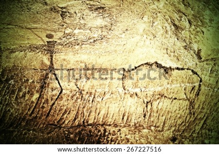 Paint of human hunting on sandstone wall, copy of prehistoric picture. Black carbon abstract children art in sandstone cave