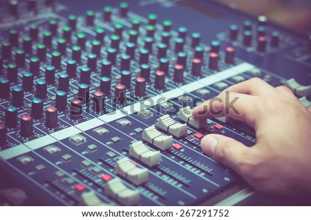 Hand adjusting audio mixer Royalty-Free Stock Photo #267291752