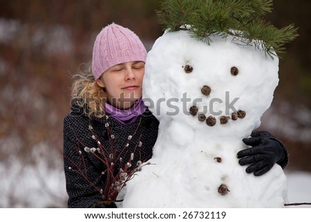 Woman portrait, eyes shut happy posing with snowman