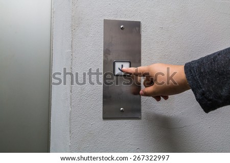 woman pressing elevator button
