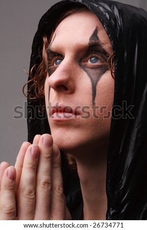 Portrait of a praying goth man
