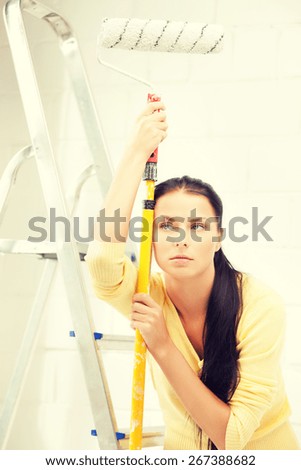picture of bored and tired young woman with paintroller