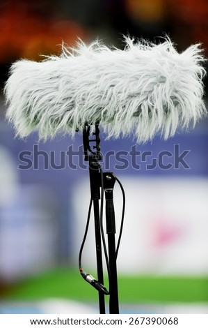 Big and furry professional sport microphone on sport field