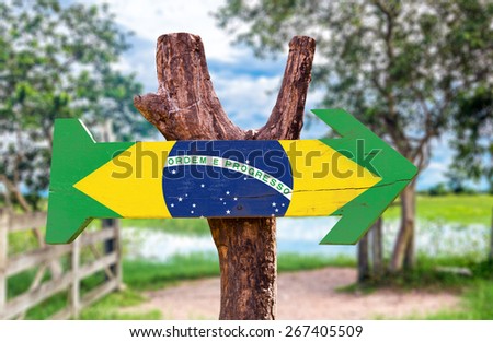 Brazil Flag wooden sign with rural background Royalty-Free Stock Photo #267405509