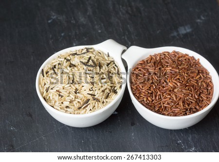 Different kinds of rice in the pots on the rustic table