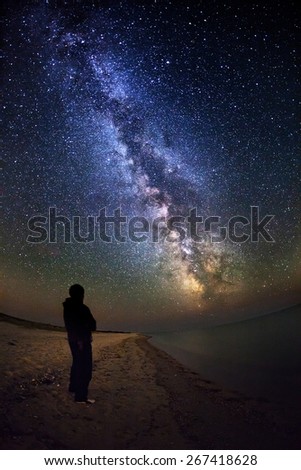 Milky Way. Beautiful summer night sky with stars and silhoette on the sea in Ukraine