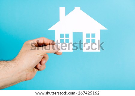 Hand holding Paper House