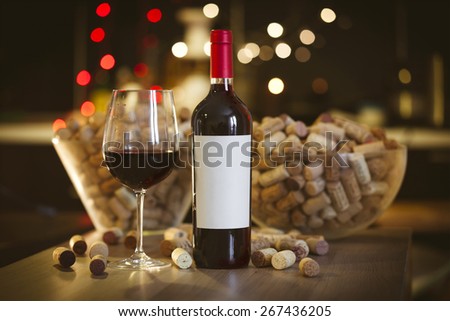 Blank label bottle of red wine with a glass