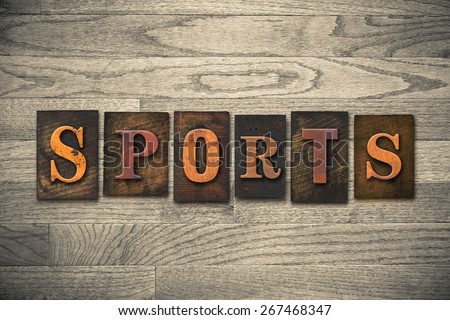 The word "SPORTS" theme written in vintage, ink stained, wooden letterpress type on a wood grained background.