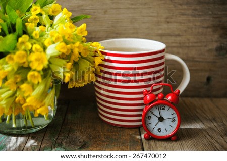Tea time, red stripped cup of tea, spring flowers and Have a nice day note