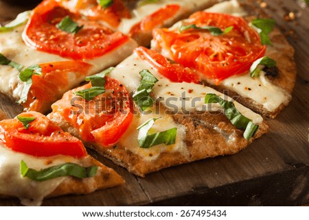 Homemade Margarita Flatbread Pizza with Tomato and Basil Royalty-Free Stock Photo #267495434