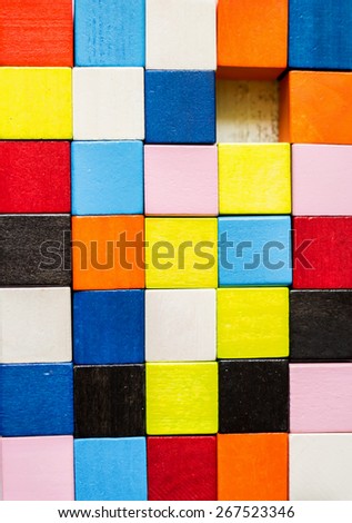 Colorful background made of wooden bricks with a hole