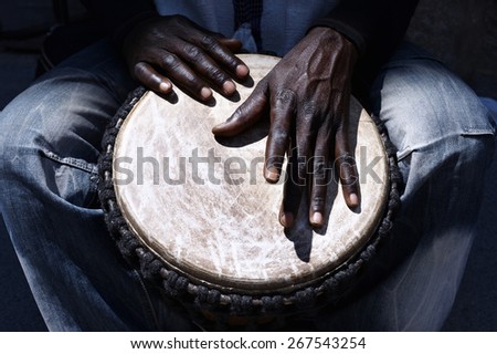 Close up of hands of a black man playing a drum Royalty-Free Stock Photo #267543254