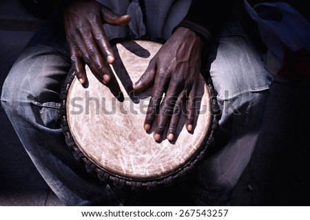 Close up of hands of a black man playing a drum Royalty-Free Stock Photo #267543257